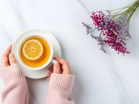 Cozy Moment with Warm Lemon Tea and Flowers on Marble Background.jpeg